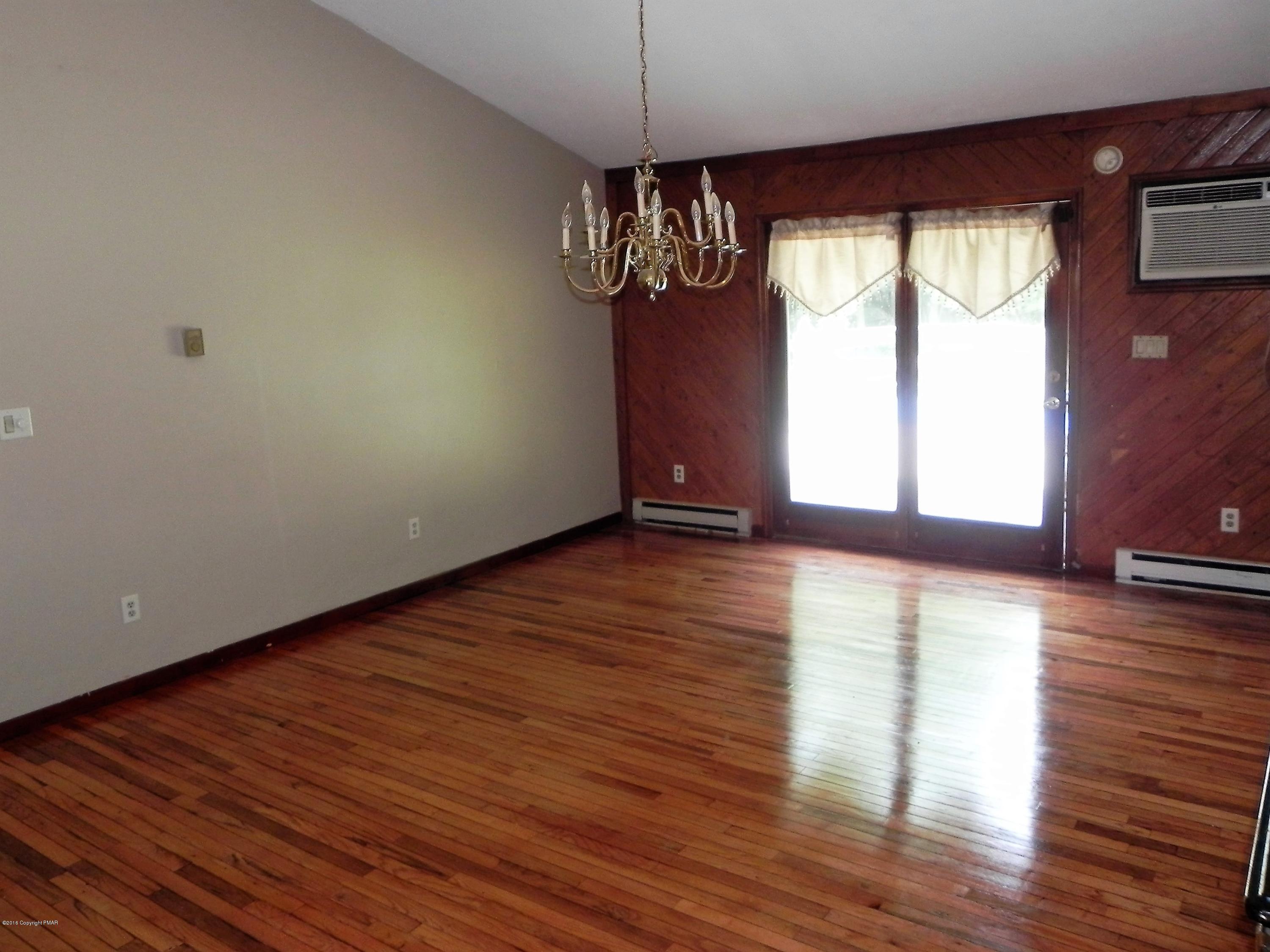 141 Rinker Road Stroudsburg, PA 18360 - Photo 6 of 29 a view of a room with wooden floor chandeliers and kitchen view