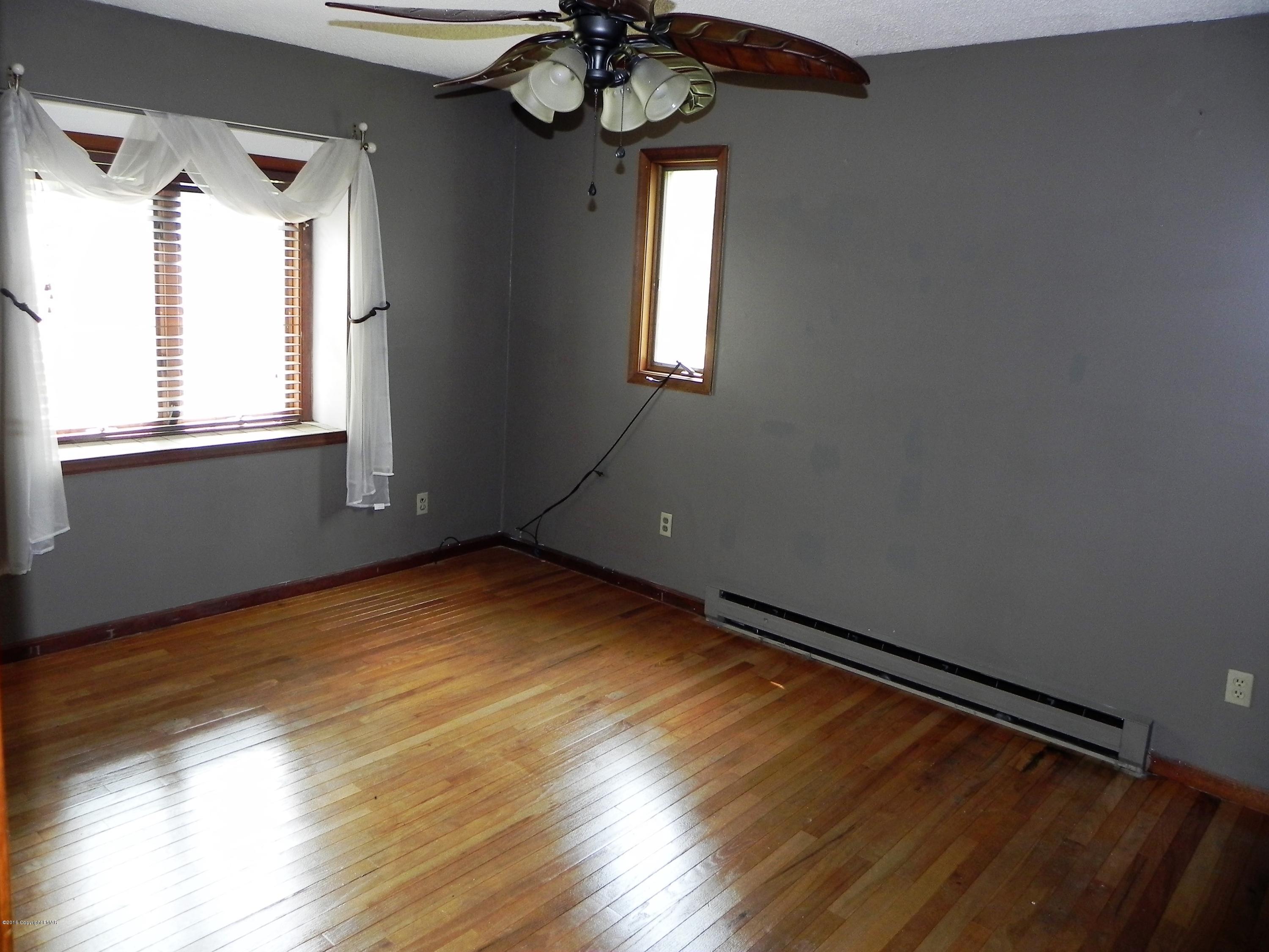 141 Rinker Road Stroudsburg, PA 18360 - Photo 9 of 29 a view of empty room with wooden floor and fan