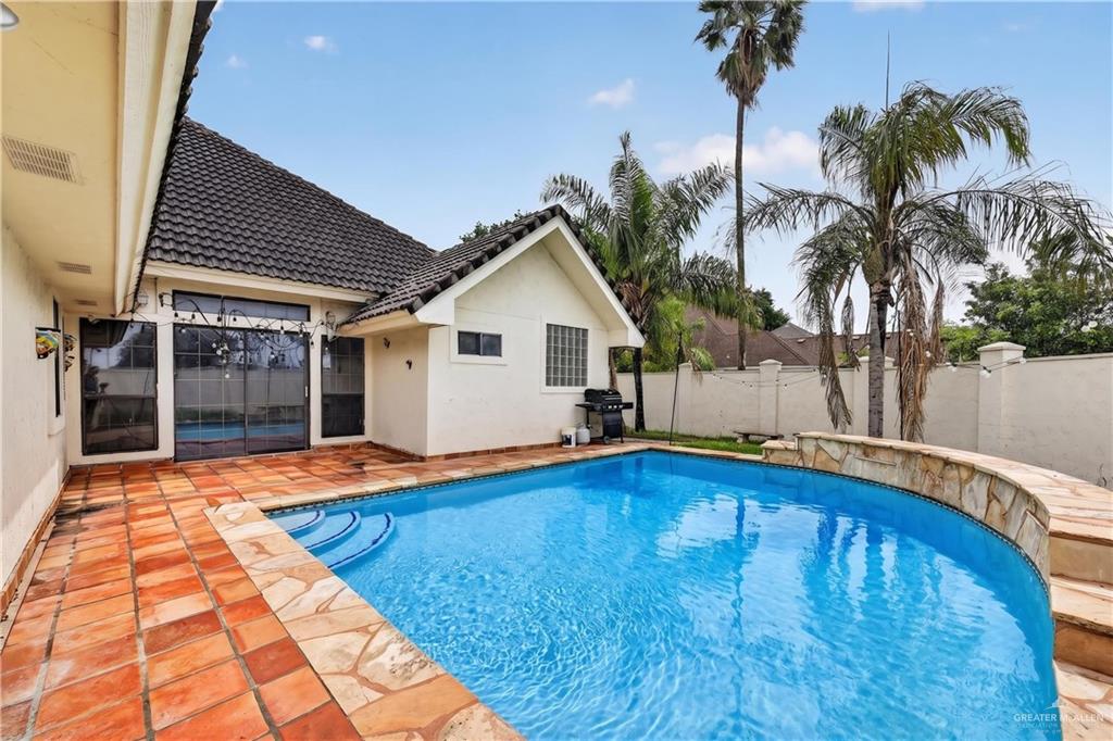 6004 North Cynthia Street McAllen, TX 78504 - Photo 24 of 25 Inviting outdoor swimming pool with integrated steps, surrounded by a terracotta tile patio
