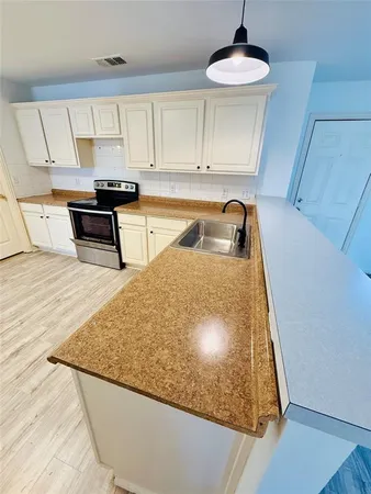 a kitchen with stainless steel appliances granite countertop a sink and a stove