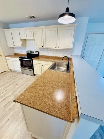 a kitchen with stainless steel appliances granite countertop a sink and a stove