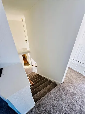 a view of an empty room and wooden floor