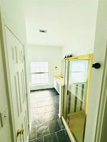 a bathroom with a tub and shower