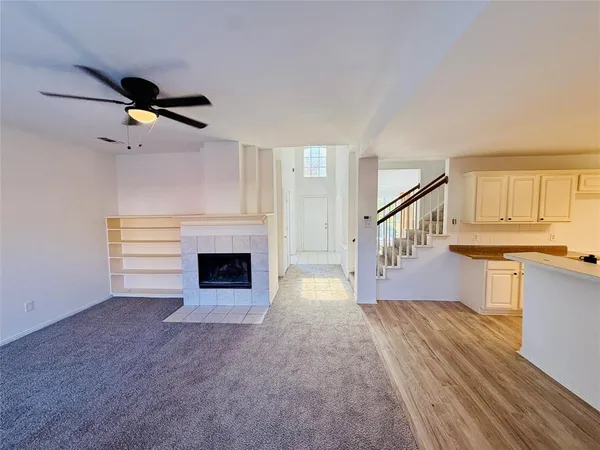 a view of an empty room and fire place