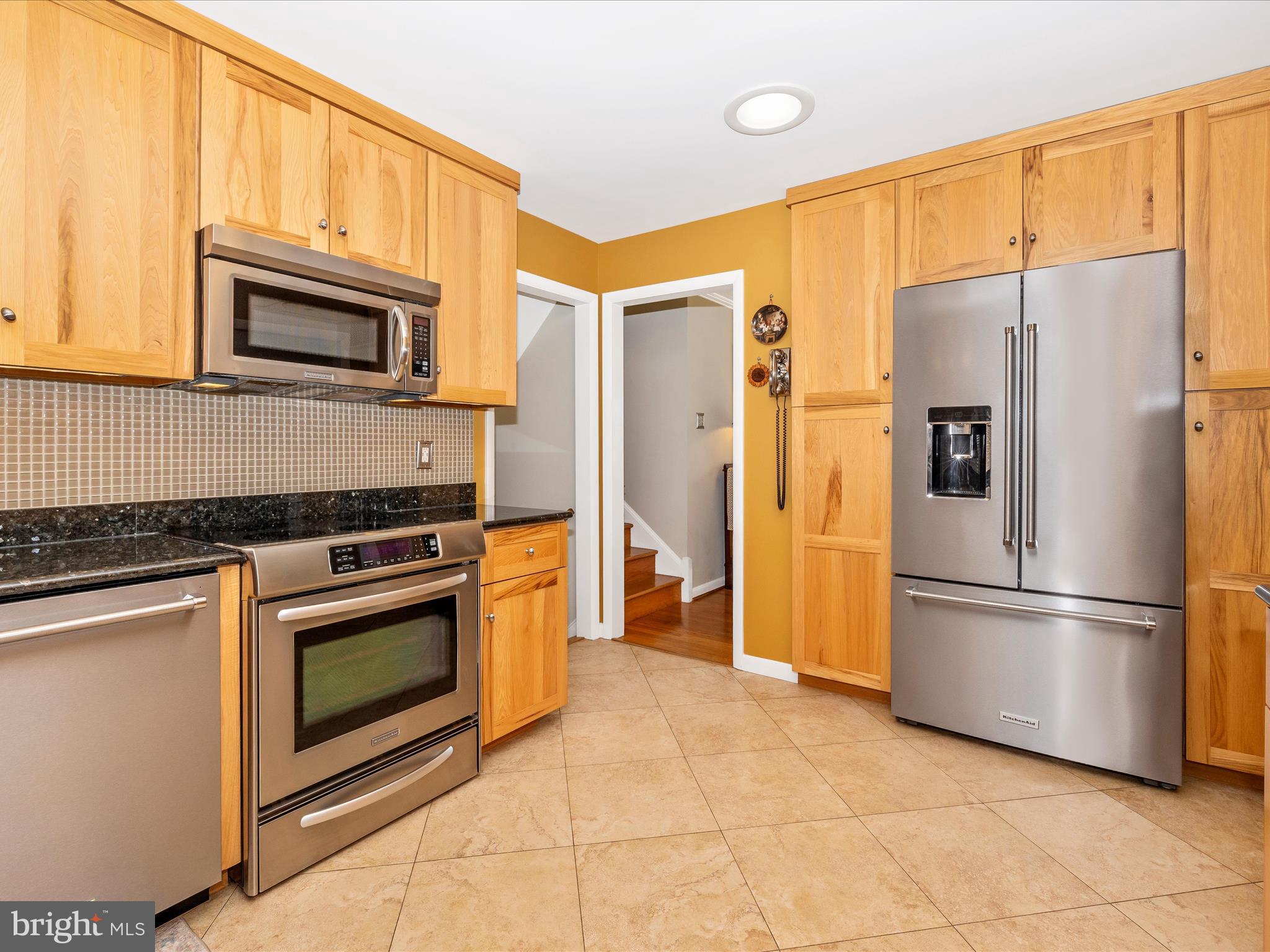 16 Kline Boulevard Frederick, MD 21701 - Photo 24 of 62 a kitchen with stainless steel appliances granite countertop a refrigerator and a stove top oven