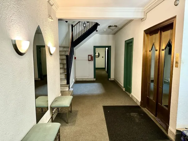 a view of entryway and hall with a chair