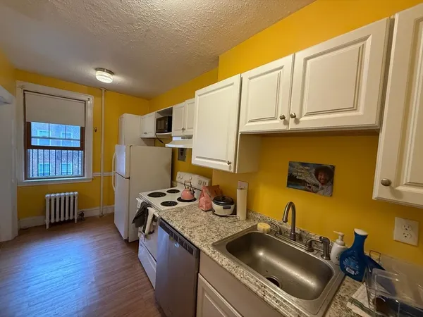 a kitchen with stainless steel appliances granite countertop a sink stove and cabinets