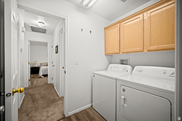 1825 West Mathis Park Place, Unit 46 St. George, UT 84770 - Photo 31 of 45 Laundry room with separate washer and dryer, cabinet space, and light wood-style flooring
