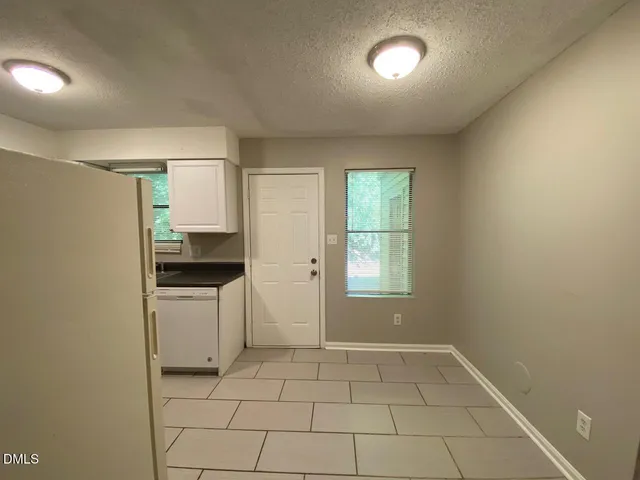 a view of a kitchen with a sink dishwasher and a microwave