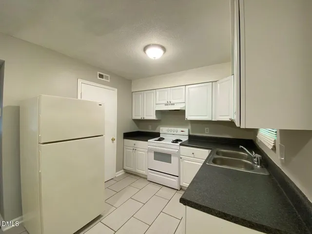 a stove top oven sitting inside of a kitchen