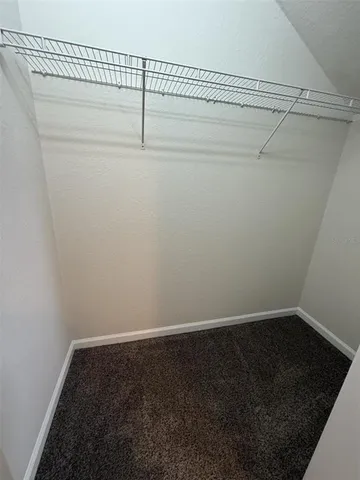 a view of an empty room with a floor to ceiling window