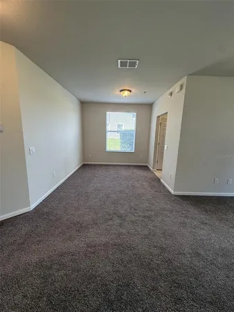 a kitchen with stainless steel appliances granite countertop a sink a stove and a window