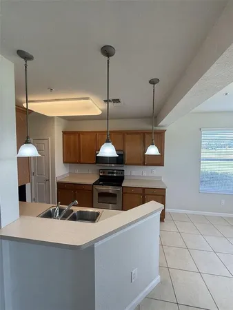 a kitchen with stainless steel appliances a refrigerator and a counter top space