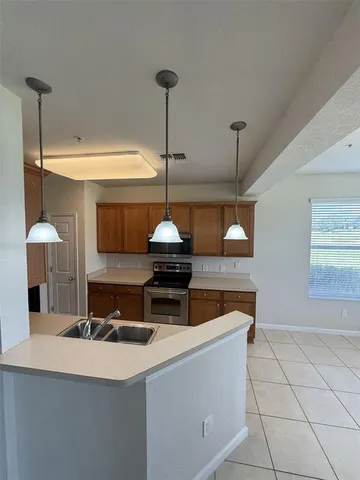 a kitchen with stainless steel appliances a refrigerator and a counter top space
