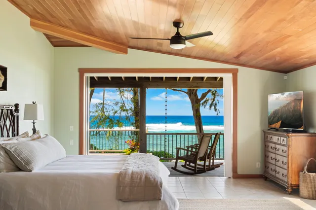 a bedroom with furniture and a flat screen tv