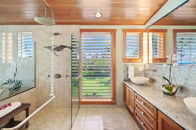 a bathroom with a granite countertop sink a toilet and shower