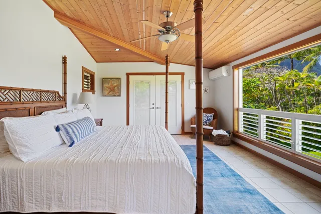 a bedroom with furniture and a large window
