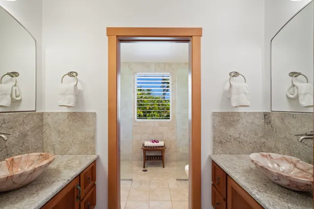 a bathroom with a granite countertop sink and a vanity