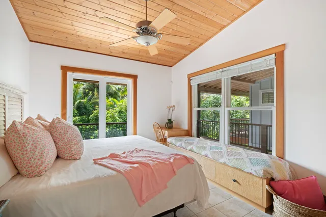 a bedroom with a large bed and a large window