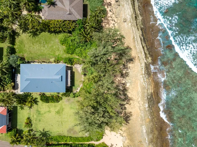 an aerial view of a house with a yard