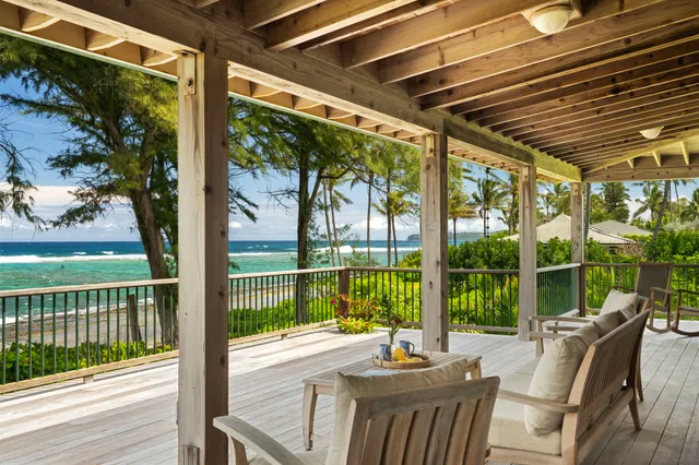 a view of a patio with a table chairs and wooden floor