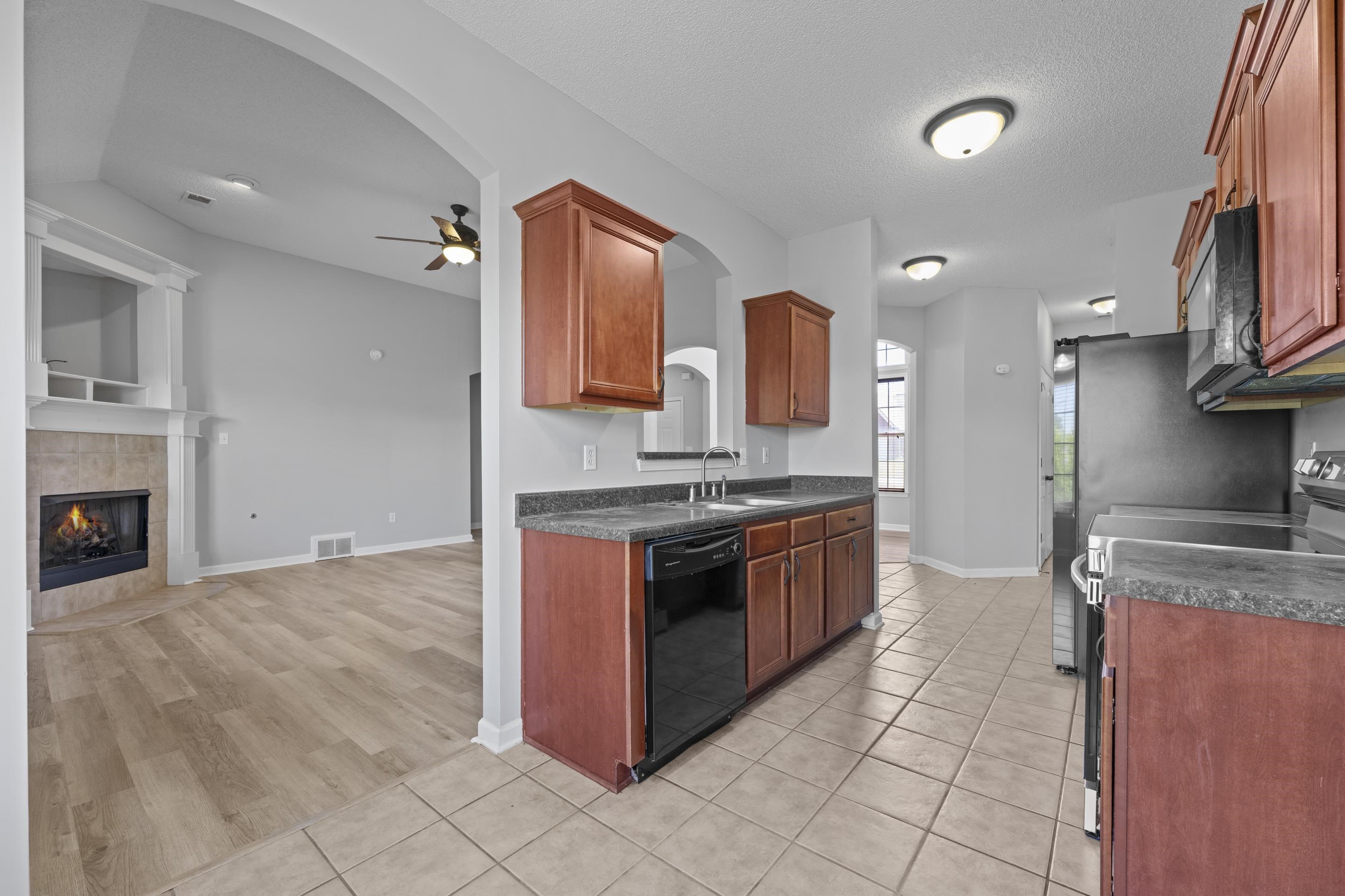 50 Abbey Road Oakland, TN 38060 - Photo 7 of 26 Kitchen featuring wood cabinetry, dark countertops, and tile flooring