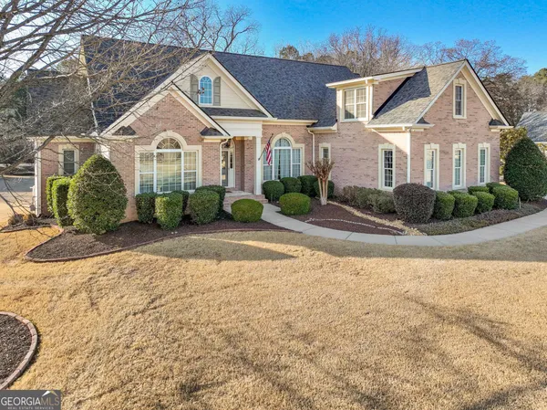 a front view of a house with a yard