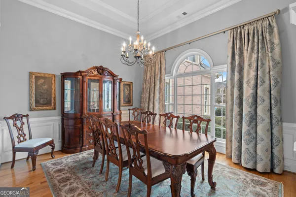 a living room with furniture a chandelier and a fireplace