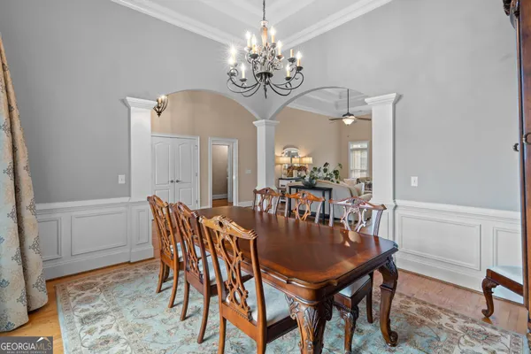 a living room with furniture potted plant and a chandelier