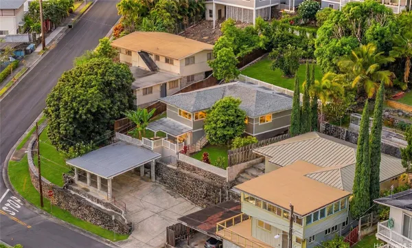 an aerial view of a house with garden space and street view