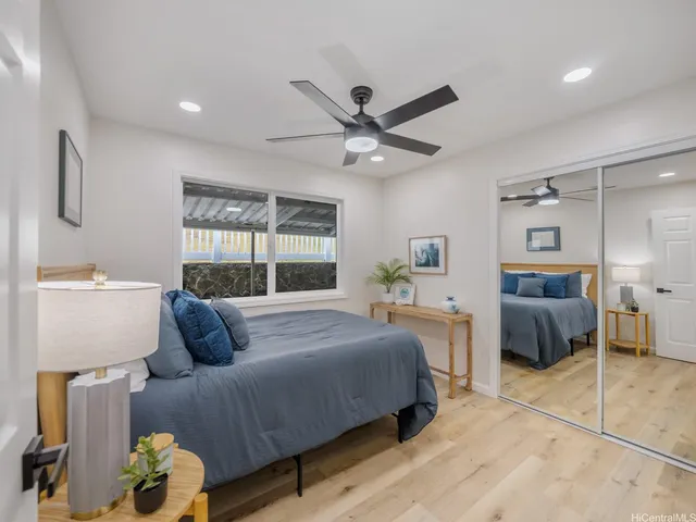 a room with furniture a flat screen tv and a refrigerator