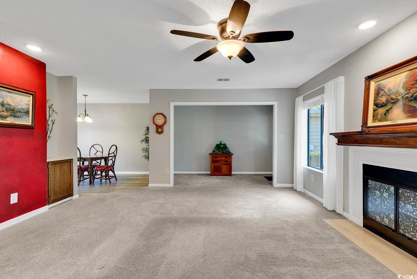 102 Berry Tree Lane Conway, SC 29526 - Photo 15 of 40 Carpeted living room with ceiling fan and a textur