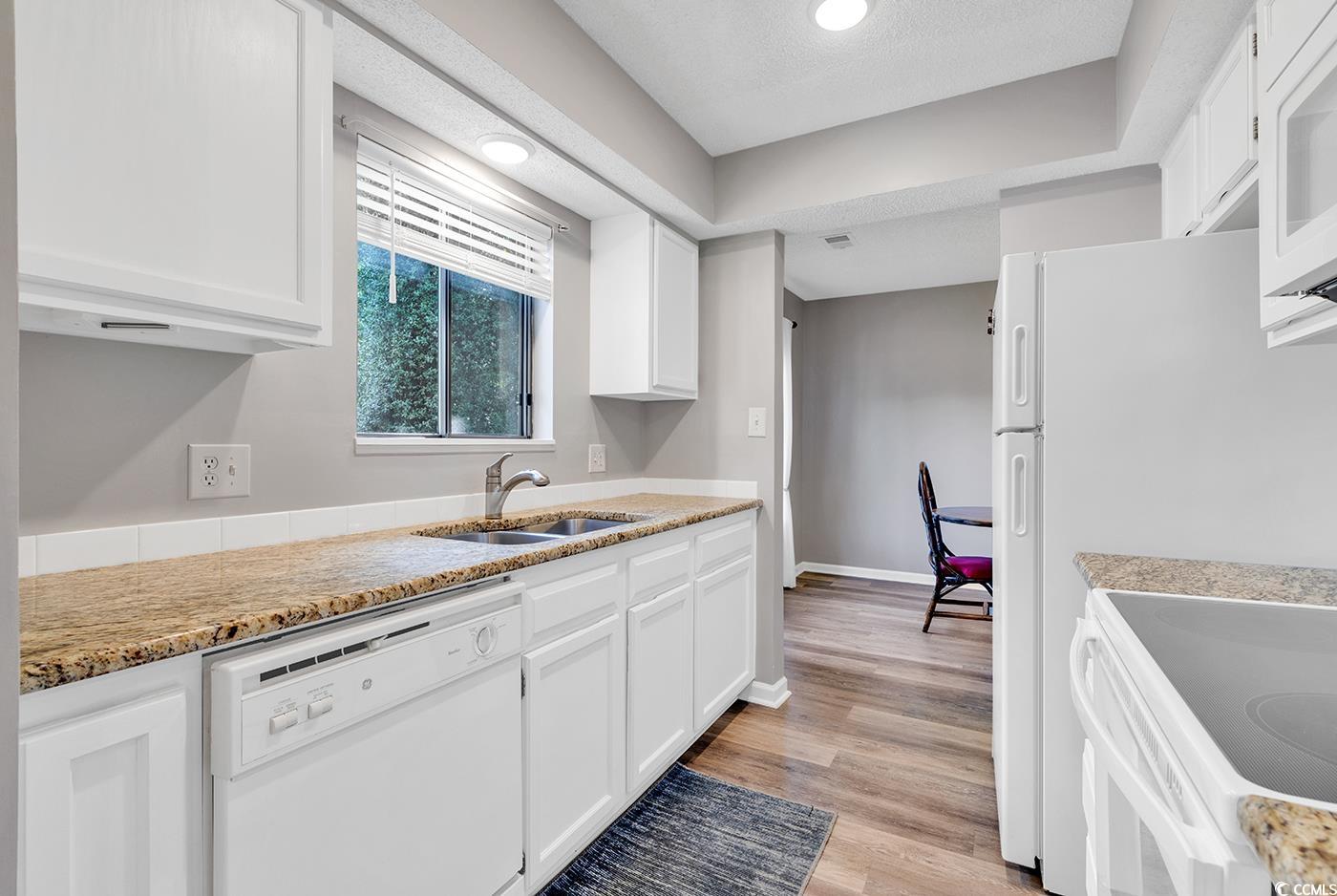 102 Berry Tree Lane Conway, SC 29526 - Photo 4 of 40 Kitchen with white cabinetry, sink, white applianc