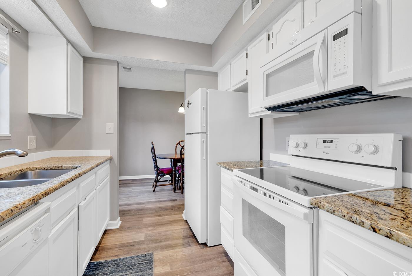 102 Berry Tree Lane Conway, SC 29526 - Photo 5 of 40 Kitchen with sink, white appliances, light hardwoo