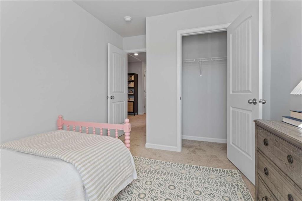 123 Meadowview Drive, Unit 15 Temple, GA 30179 - Photo 17 of 24 a bedroom with a bed and a dresser in it