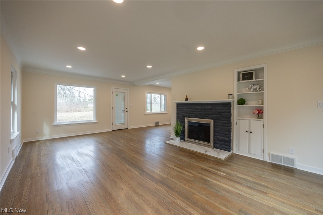 32887 Cedar Road Mayfield Heights, OH 44124 - Photo 5 of 44 Unfurnished living room with hardwood / wood-style floors, a fireplace, and ornamental molding