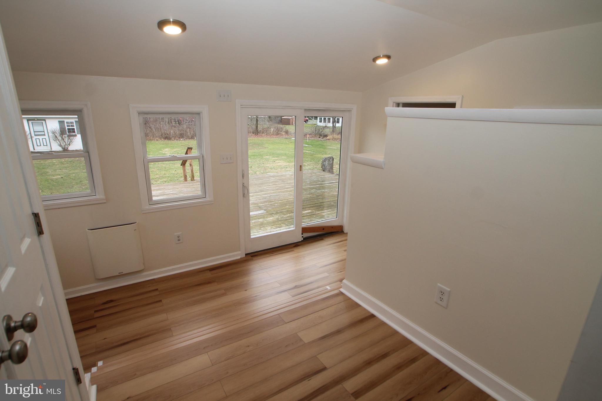 5871 Stump Road Pipersville, PA 18947 - Photo 12 of 33 an empty room with wooden floor and windows