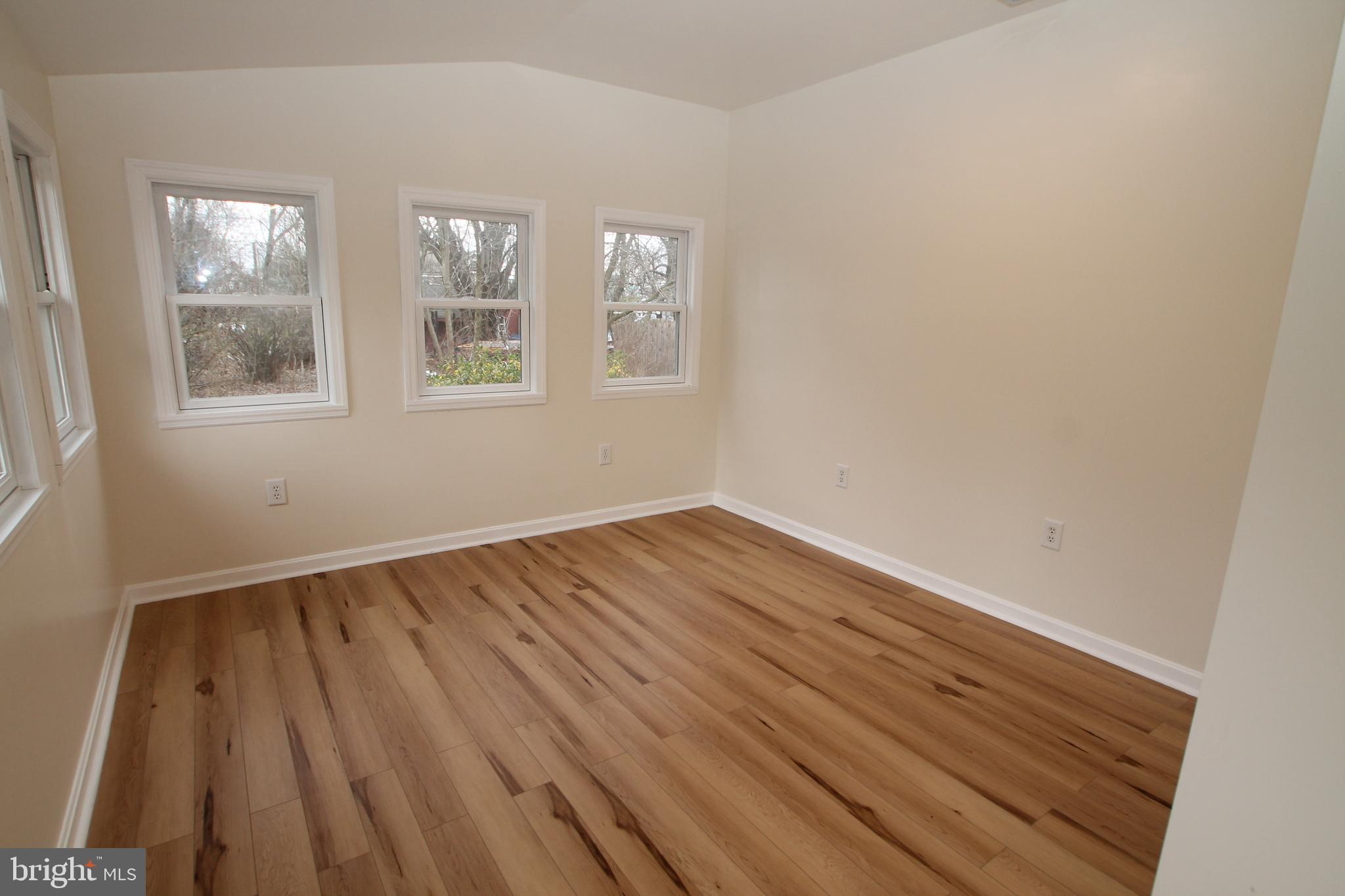 5871 Stump Road Pipersville, PA 18947 - Photo 14 of 33 a view of an empty room with wooden floor and a window