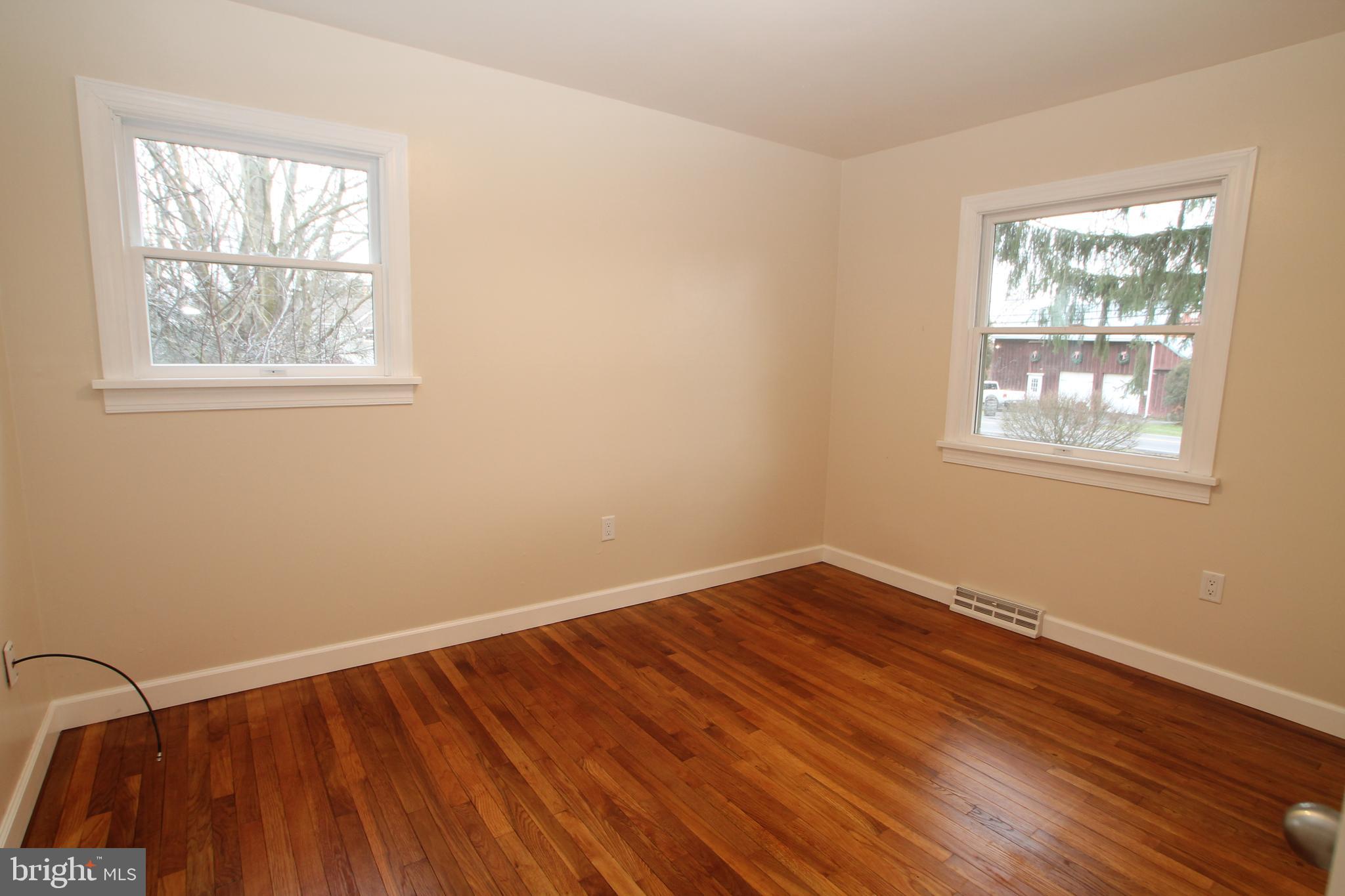 5871 Stump Road Pipersville, PA 18947 - Photo 20 of 33 a view of an empty room with wooden floor and a window