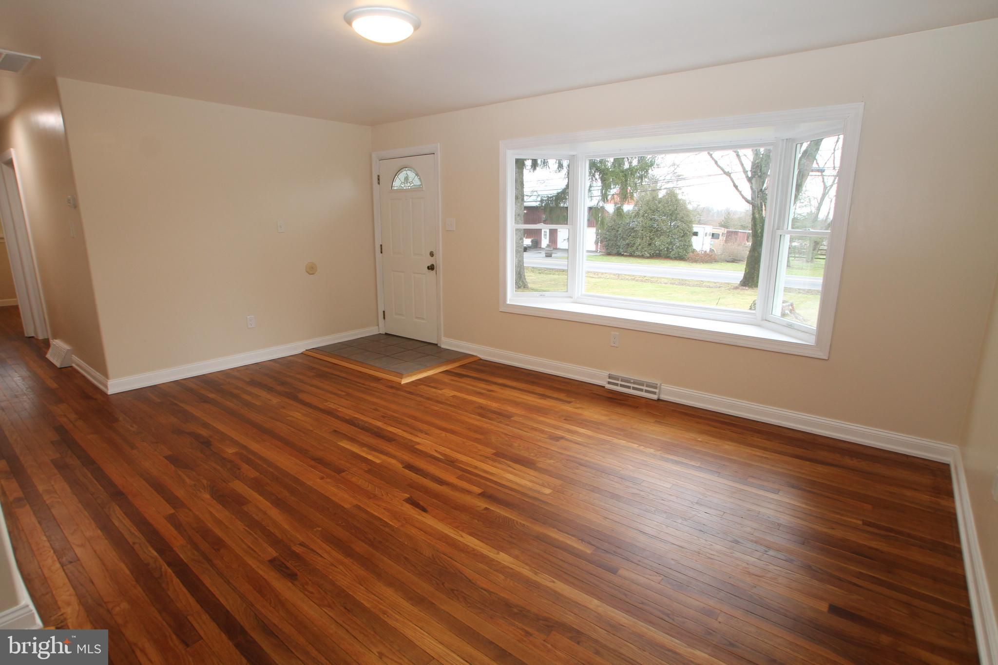 5871 Stump Road Pipersville, PA 18947 - Photo 5 of 33 an empty room with wooden floor and windows