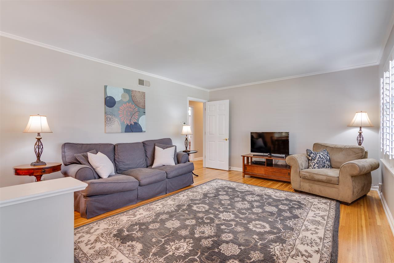 View as you enter the home.  Note the gleaming hardwood floors, fresh neutral paint, and plantation shutters.