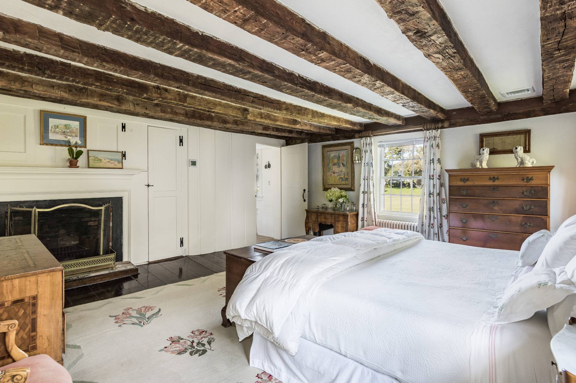 117 Egypt Lane East Hampton, NY 11937 - Photo 23 of 36 a bedroom with a bed and a fireplace