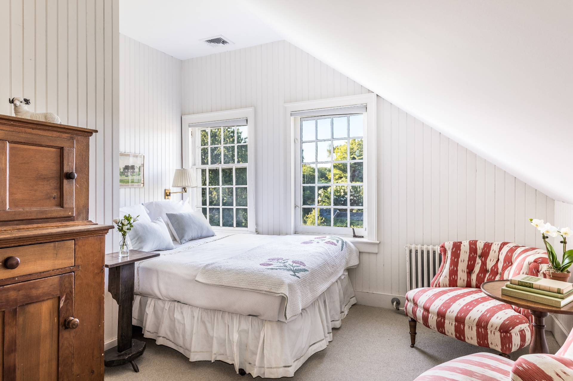 117 Egypt Lane East Hampton, NY 11937 - Photo 33 of 36 a bedroom with a bed and wooden floor