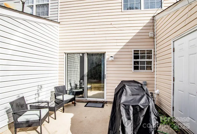 a view of backyard with outdoor seating and patio