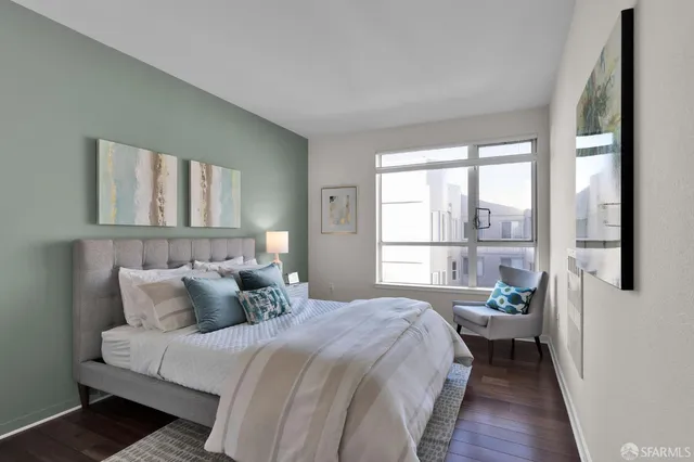 a bedroom with a large bed and a large window