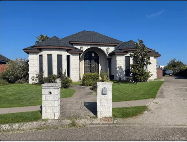 a front view of a house with a garden