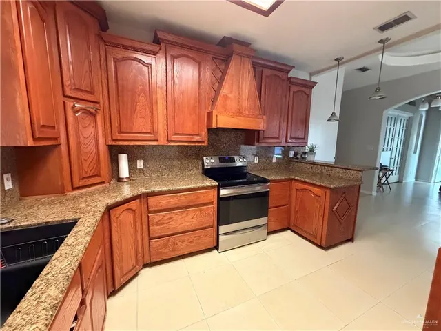 a kitchen with stainless steel appliances granite countertop wooden cabinets a sink and dishwasher