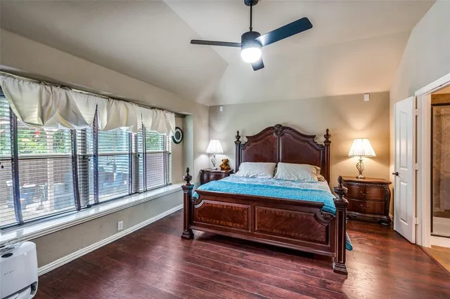 a room with stainless steel appliances kitchen island granite countertop a refrigerator and a stove top oven