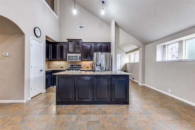 a bathroom with a granite countertop sink a mirror and shower