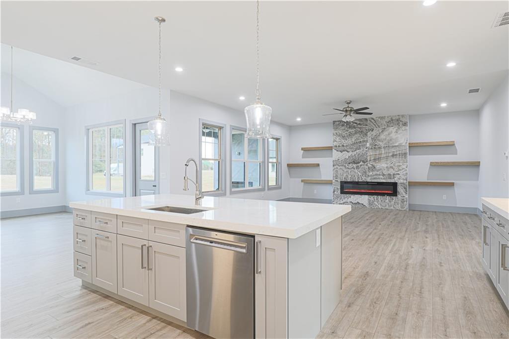 1341 Wheeler Creek Road Maysville, GA 30558 - Photo 2 of 51 a kitchen with a sink and dishwasher with wooden floor